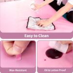 Pink rectangular ASTONFOG PU leather lash bed cover on a professional massage table, showcasing its smooth, waterproof surfac