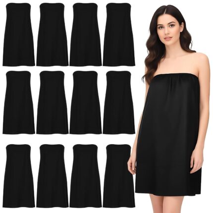 A stack of individually wrapped black disposable spa wraps for women, showing the soft non-woven material.