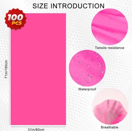 Stack of 100 pink disposable waterproof massage table sheets, unfolded to show texture.