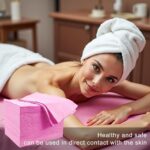 Stack of 100 pink disposable waterproof massage table sheets, unfolded to show texture.