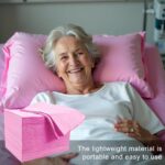 Stack of 100 pink disposable waterproof massage table sheets, unfolded to show texture.