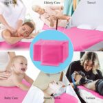 Stack of 20 pink disposable non-woven fabric massage table sheets, folded neatly.