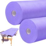 Two rolls of purple Tudomro disposable non-woven massage table sheets, unrolled slightly to show texture.