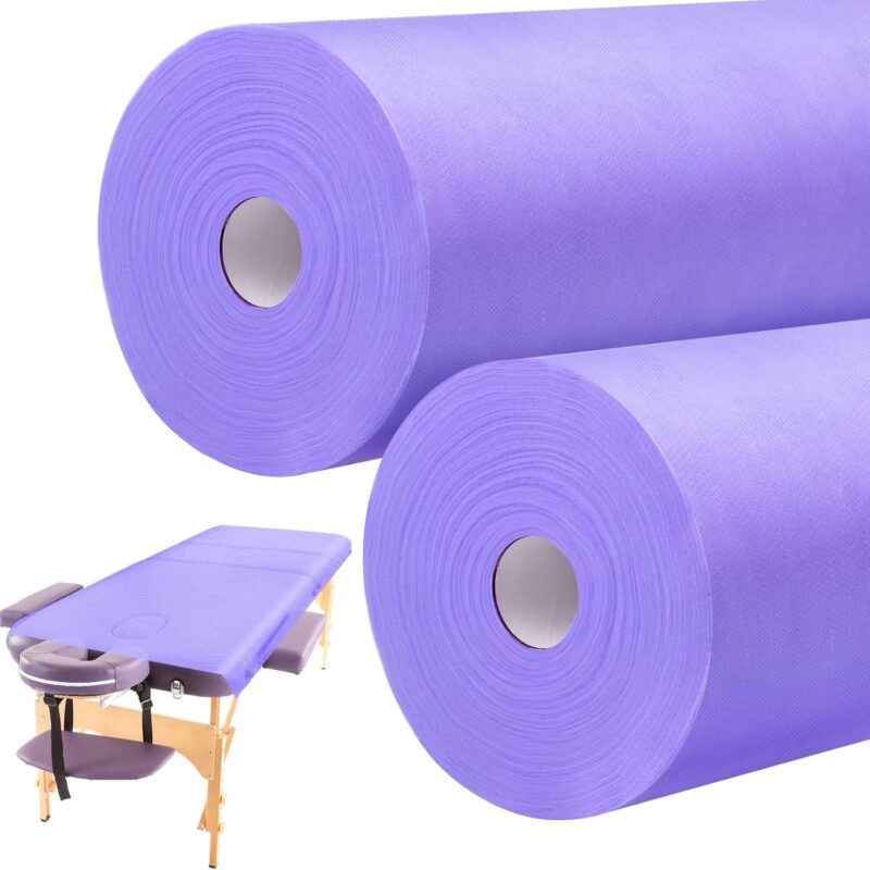 Two rolls of purple Tudomro disposable non-woven massage table sheets, unrolled slightly to show texture.