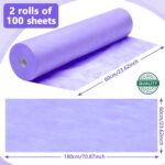 Two rolls of purple Tudomro disposable non-woven massage table sheets, unrolled slightly to show texture.