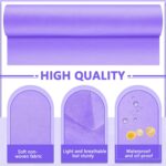 Two rolls of purple Tudomro disposable non-woven massage table sheets, unrolled slightly to show texture.