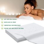 Stack of 100 white disposable non-woven bed sheets for massage tables and spa beds, neatly folded.