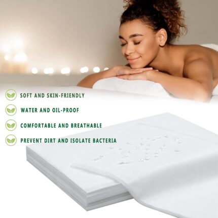 Stack of 100 white disposable non-woven bed sheets for massage tables and spa beds, neatly folded.